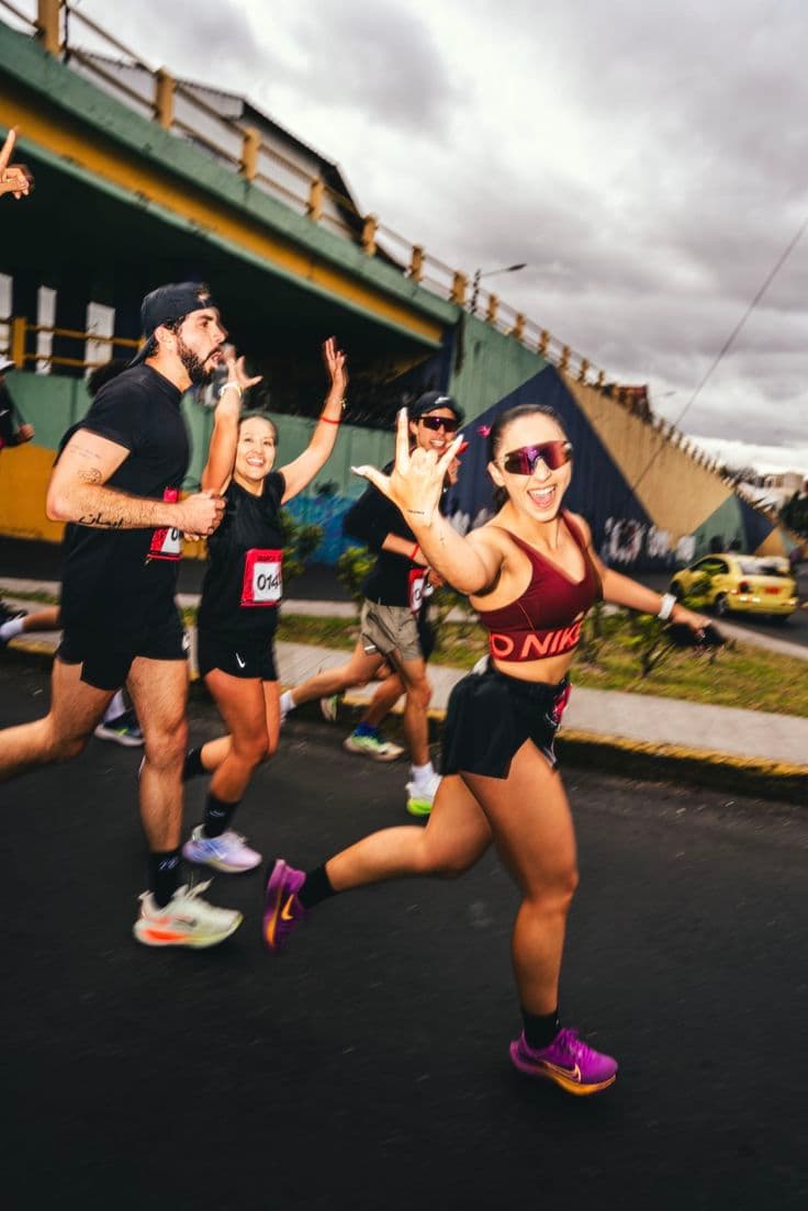 Group of smiling runners during a city race.
